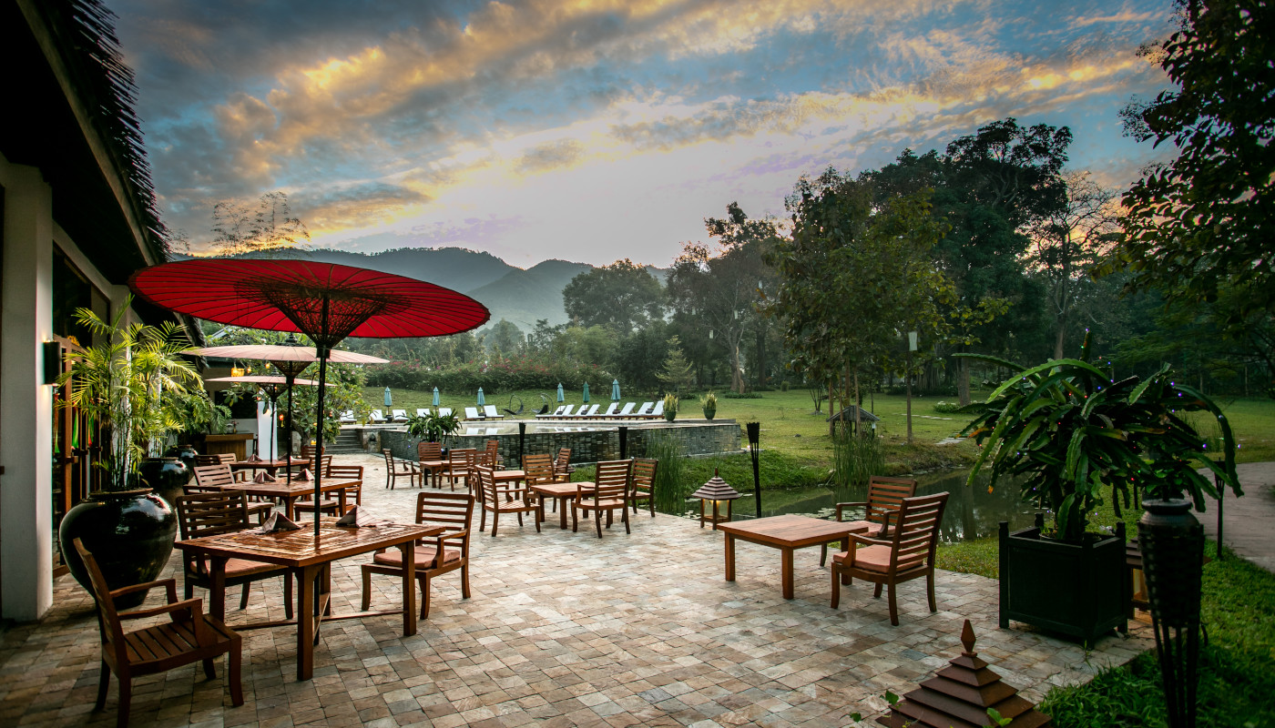 Private balcony of a Villa Inle suite overlooking the misty Inle Lake at sunrise